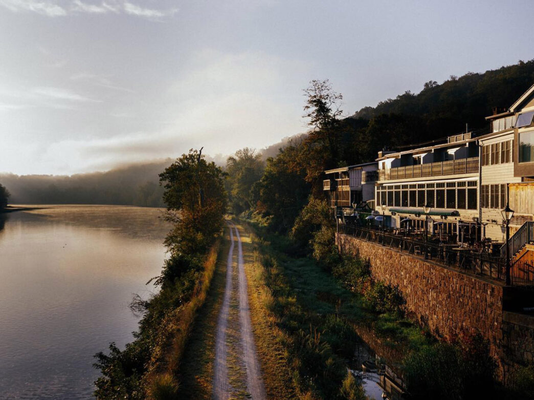 Exterior shot of the Black Bass Hotel overlooking the water