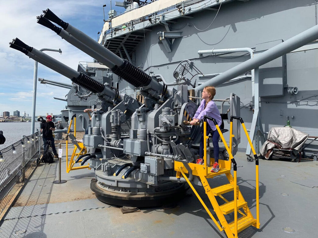 Kid operating a cannon on the Battleship New Jersey