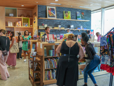 Group browsing books at Julia de Burgos Bookstore at Taller Puertorriqueño.