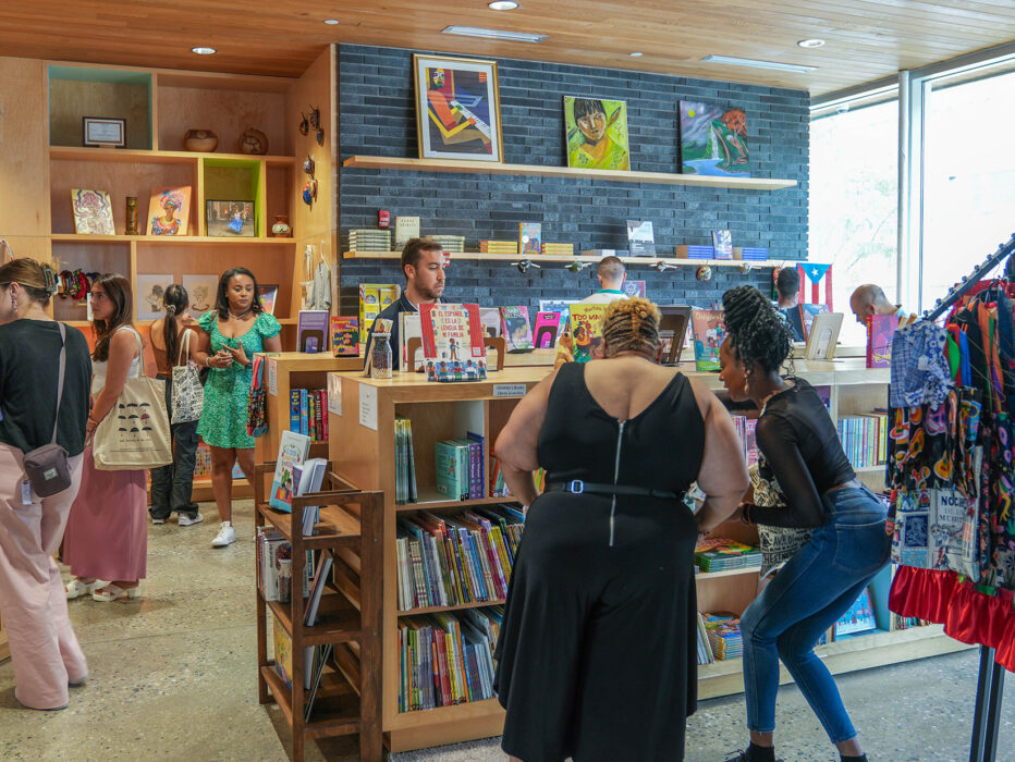 Group browsing books at Julia de Burgos Bookstore at Taller Puertorriqueño.