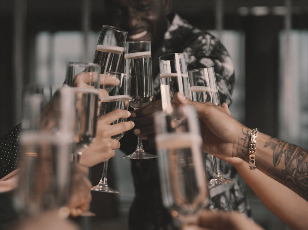 People toasting glasses at Fitler Club
