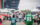 A man tosses a football to a young child in the parking lot of Lincoln Financial Field during a tailgate party.
