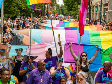 People carrying the giant flag from Pride and OURfest