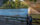 People walk along the Schuylkill River Trail while rowers during the Head of the Schuylkill Regatta row past in Philadelphia
