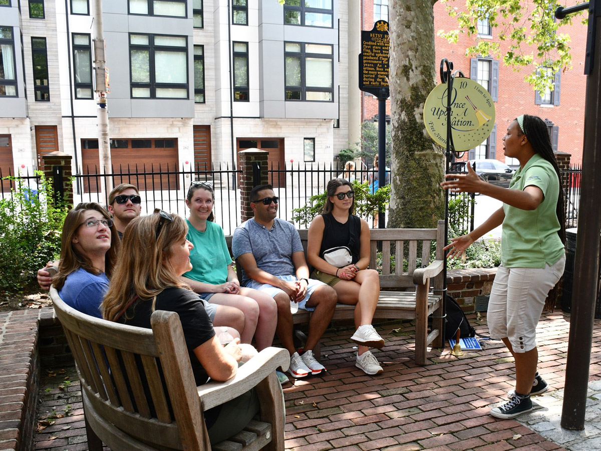 Presenter and group at the Betsy Ross House Once Upon a Nation Storytelling Bench