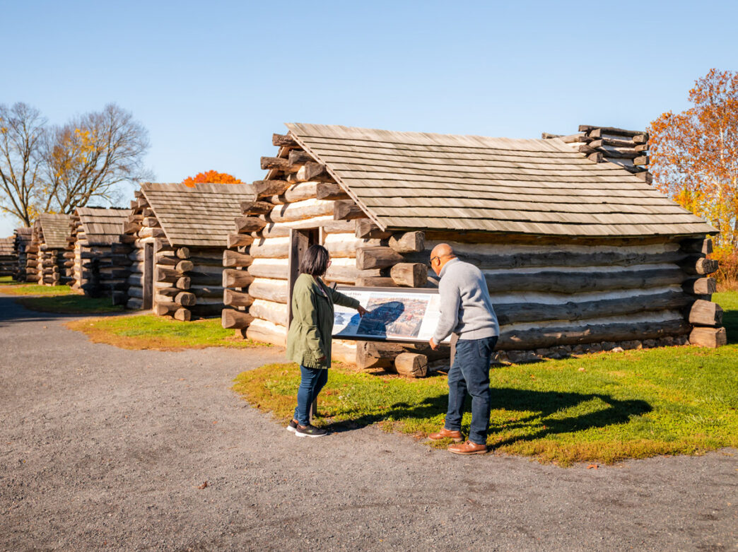 People looking at huts at Valley Forge National Historical Park