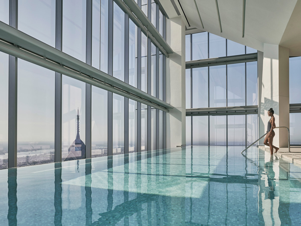 Woman stepping into the infinity pool at the Four Seasons