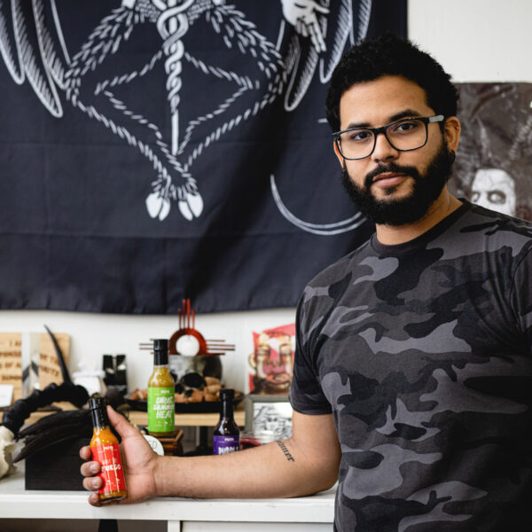 Radhi Fernandez next to his FAIYA hot sauce brand