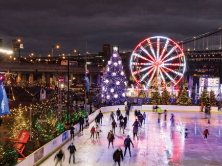 People ice skate at Blue Cross RiverRink Winterfest in Philadelphia