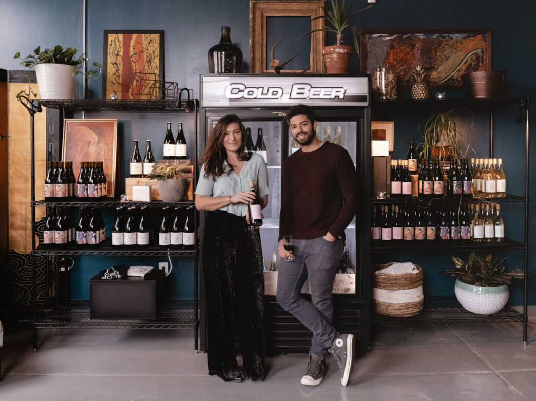 Francesca & Nicholas of Mural City Cellars standing in front of beer and wine