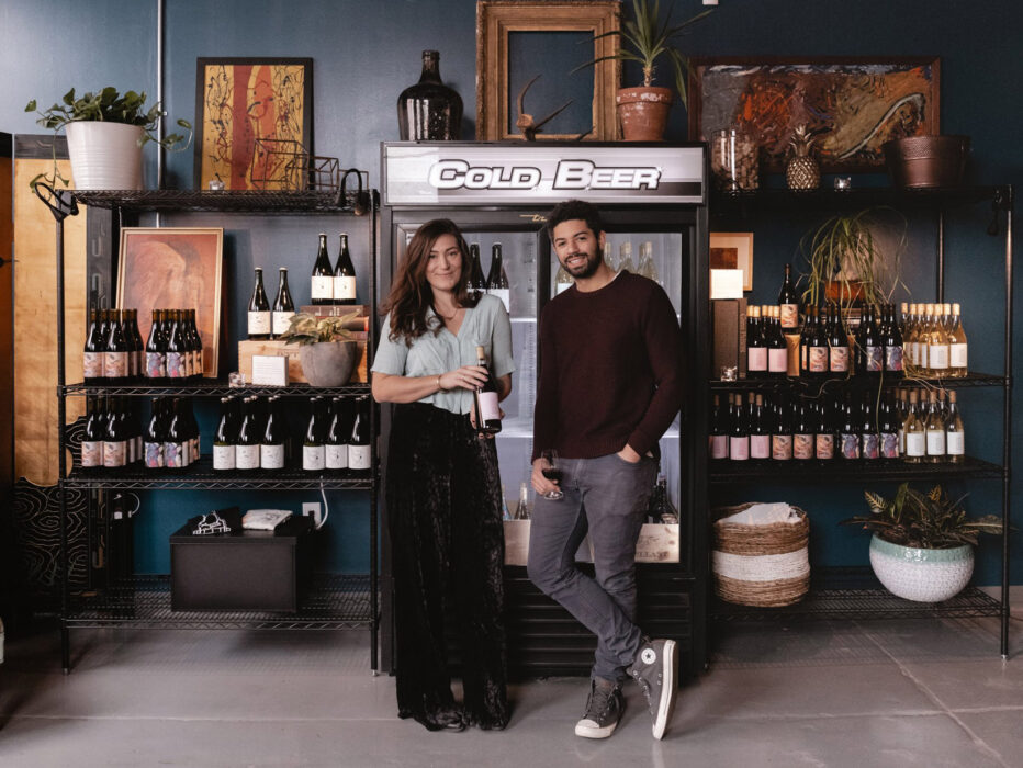 Francesca & Nicholas of Mural City Cellars standing in front of beer and wine