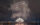 White and gold fireworks explode in the night sky over the Delaware River.
