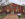 Exterior entrance to Arch Street Meeting House, a red brick building with cream window frames and shutters, light posts and signage.