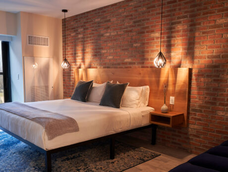 A bed against a brick wall at The Maj in Philadelphia
