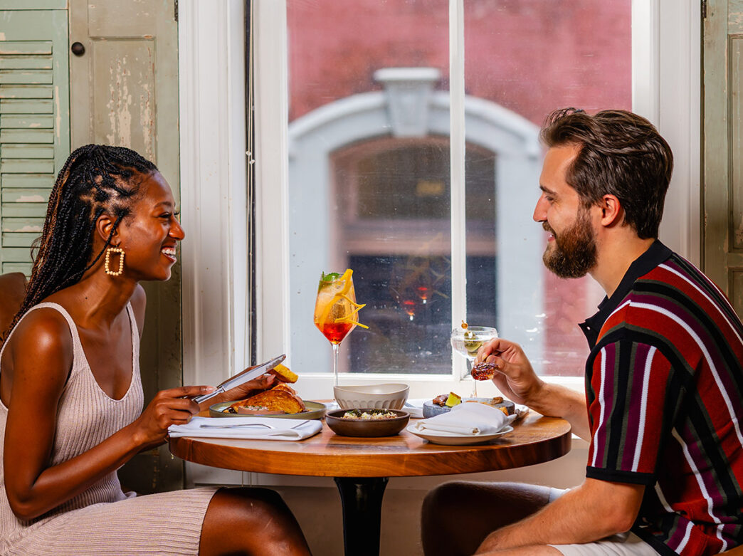 Couple at table eating meal at Friday Saturday Sunday