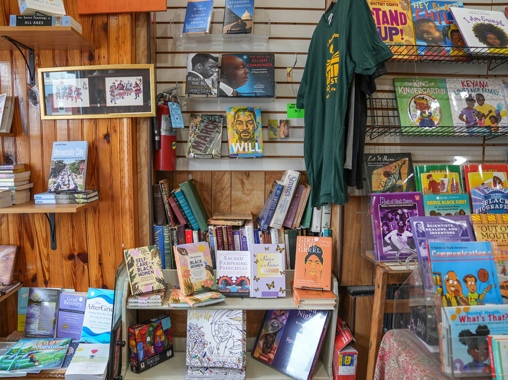 Wall and bookshelves displaying African American books at Hakim's Bookstore in Philadelphia.