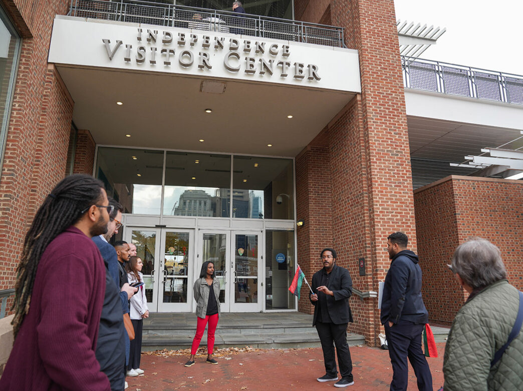 Two tour guides on The Black Journey tour speak in front of Independence Visitor Center in Philadelphia