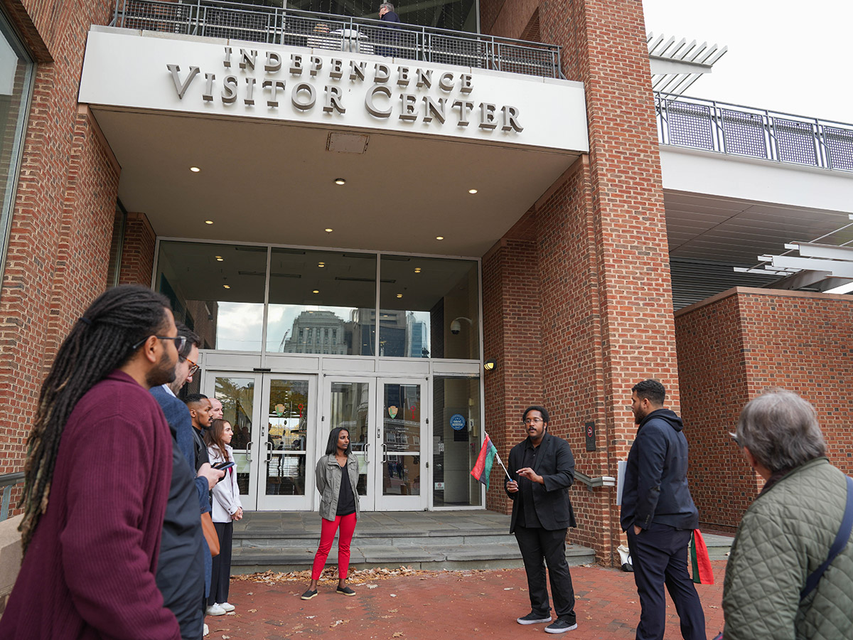 Two tour guides on The Black Journey tour speak in front of Independence Visitor Center in Philadelphia