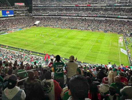 Crowds watch and cheer at a soccer game at Lincoln Financial Field.