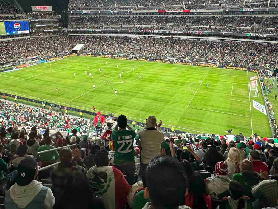 Crowds watch and cheer at a soccer game at Lincoln Financial Field.