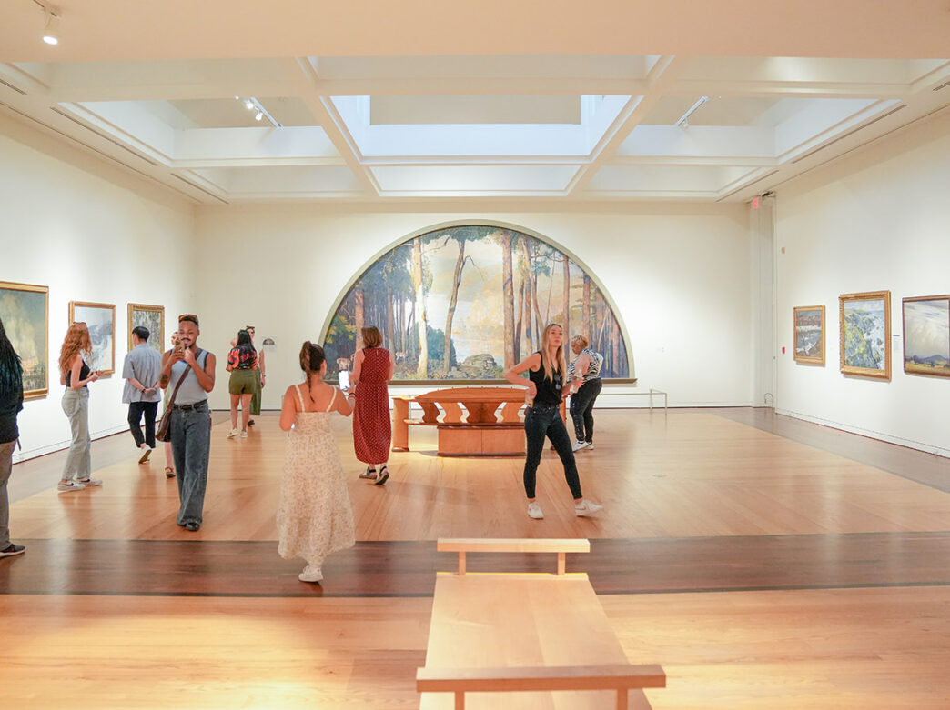 Visitors walk through the gallery at the Michener Art Museum.