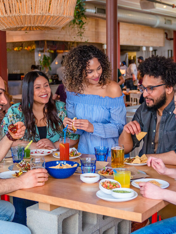 A group of 5 people dine and drink together at Mission Taqueria in Philadelphia.