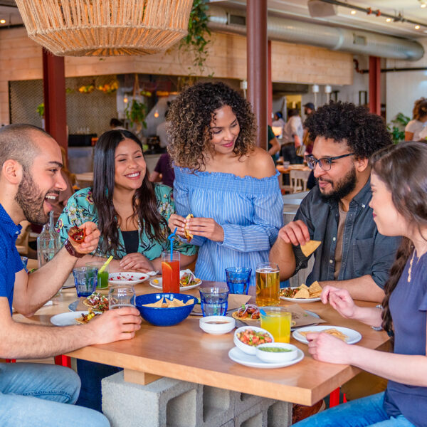 A group of 5 people dine and drink together at Mission Taqueria in Philadelphia.