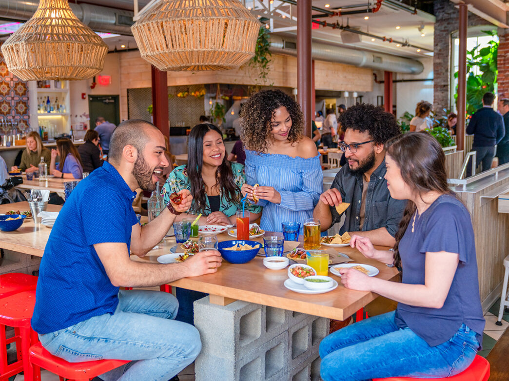 A group of 5 people dine and drink together at Mission Taqueria in Philadelphia.