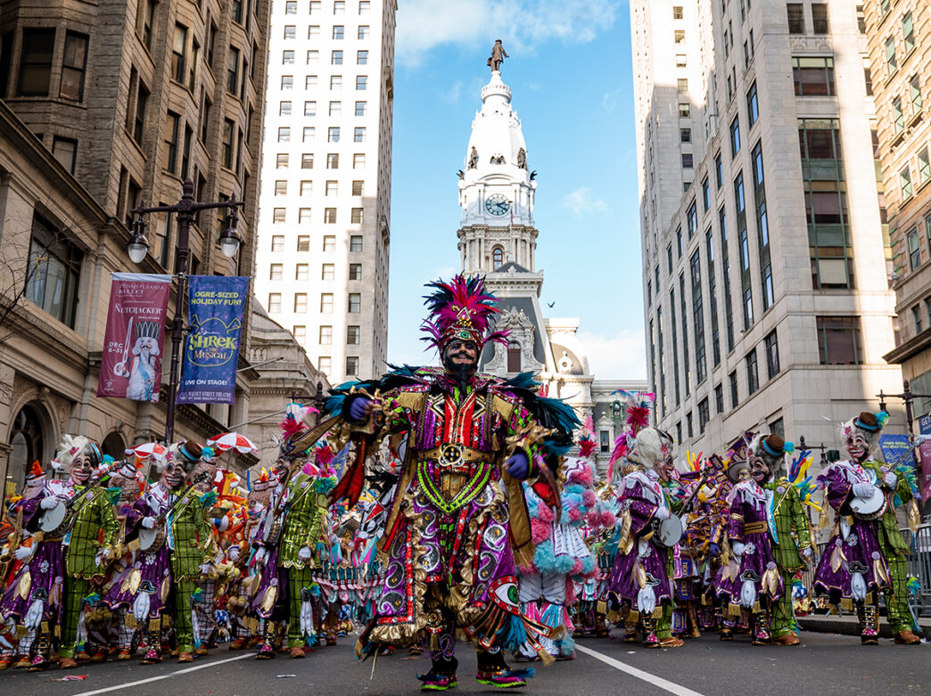 A group of mummers in brightly colored costumes walk in the Mummers Parade on New Year's Day in Philadelphia.