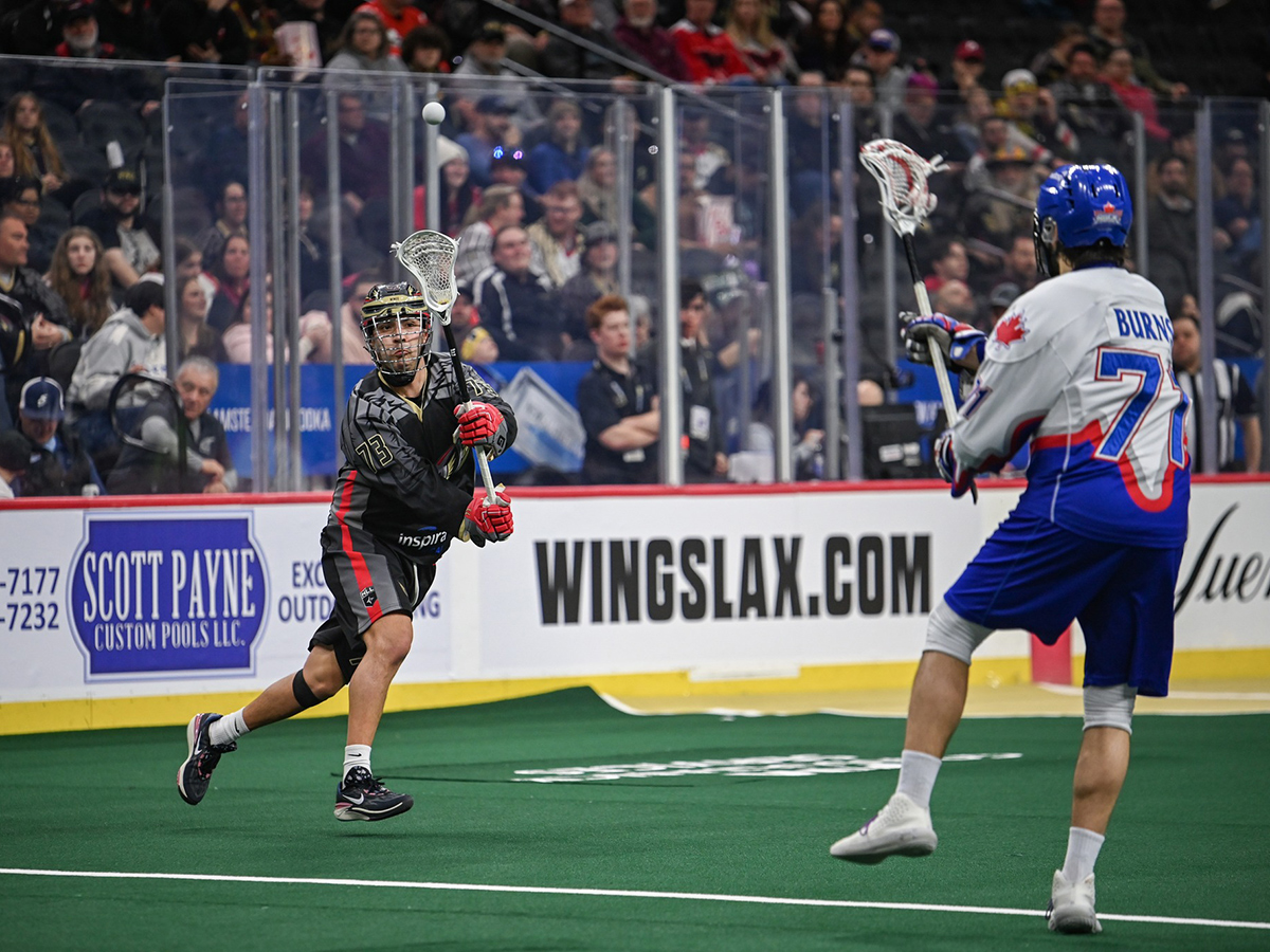 Philadelphia Wings player intercepts a lacrosse ball during a game against the Toronto Rock.