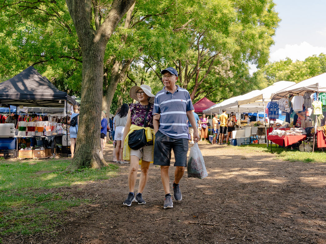 A couple strolls through the Southeast Asian Market in Philadelphia on a summer day.