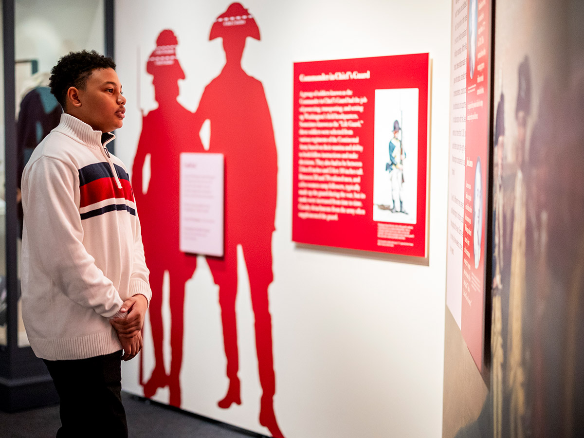 A young guest exploring the Witness to Revolution exhibit.