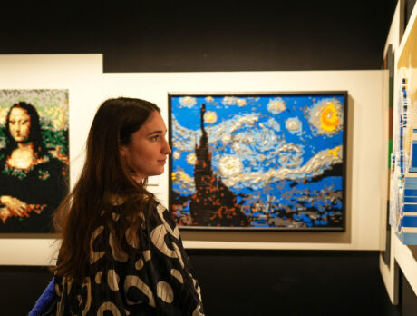 Woman looking at LEGO recreations of classic art at The Art of the Brick at The Franklin Institute