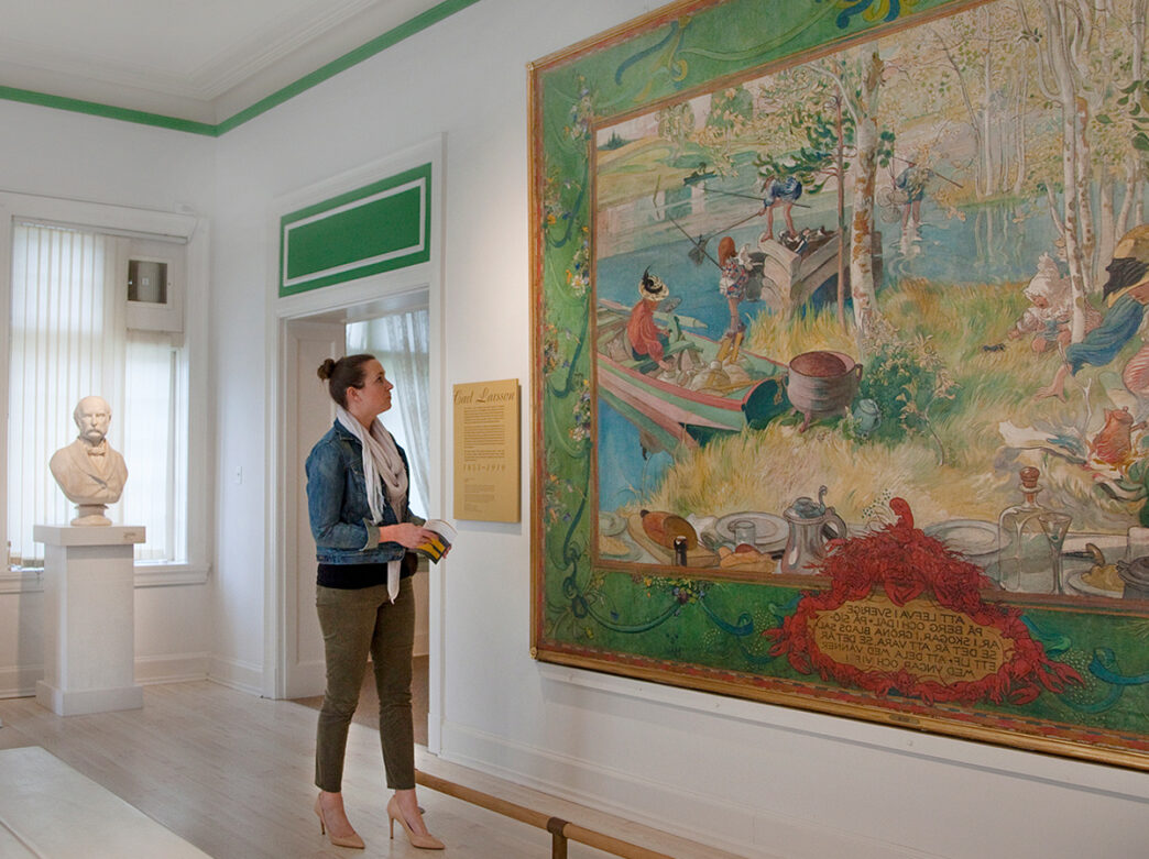 A person stops to look at a large colorful painting at the American Swedish Historical Museum in Philadelphia.