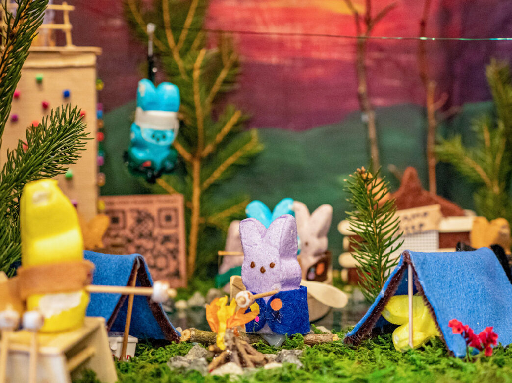 A diorama scene of bunny PEEPS® camping and roasting s'mores at Peddler's Village.