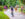 A biker wearing a helmet and teal sneakers rides along the Schuylkill River Trail amongst other bikers and walkers.