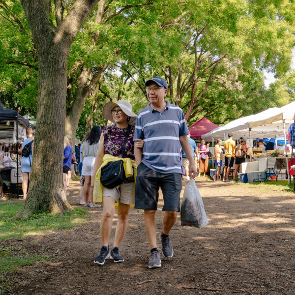 A couple strolls through the Southeast Asian Market in Philadelphia on a summer day.