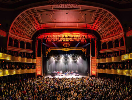 A band performs on stage at The Met in Philadelphia while the crowd faces the stage.