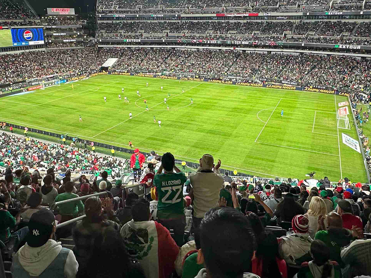 Crowds watch and cheer at a soccer game at Lincoln Financial Field.