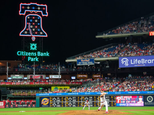 A baseball game takes place at Citizens Bank Park at night.