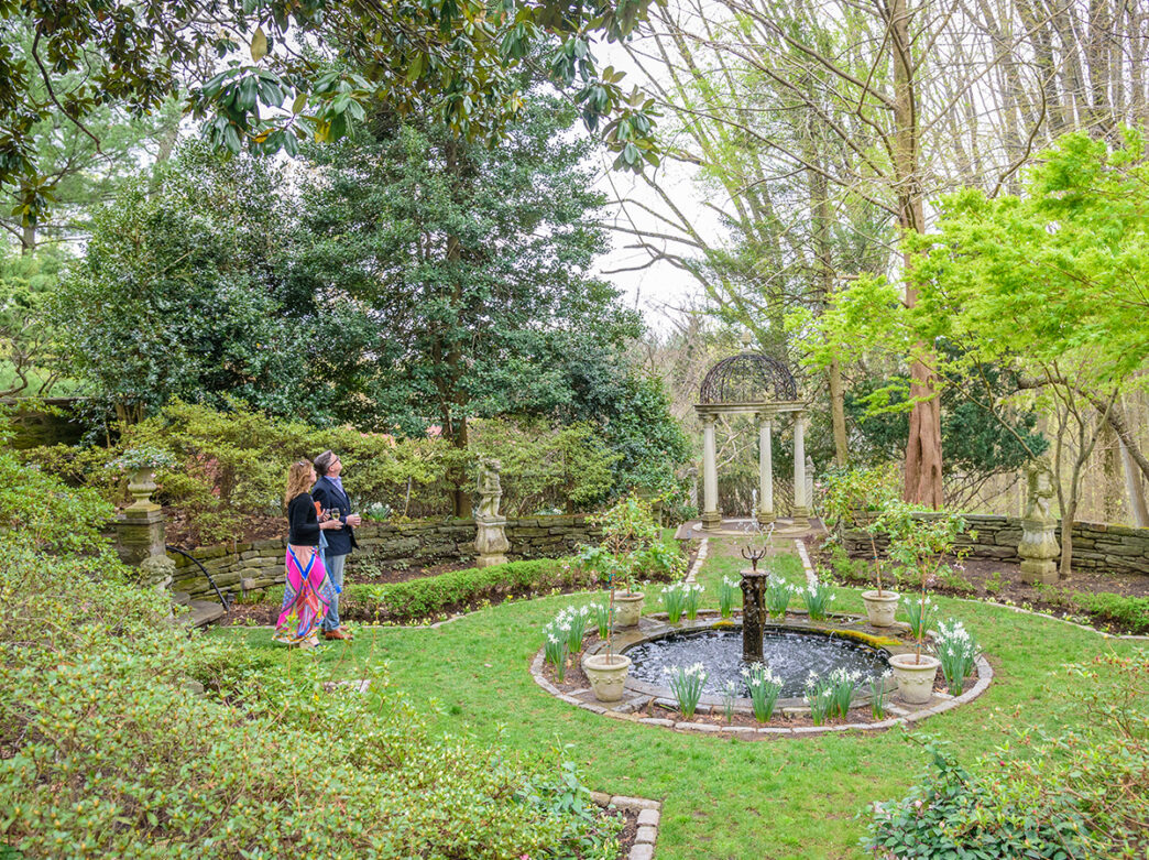 Two people look up to the sky while walking around the gardens at PHS Meadowbrook Farm.