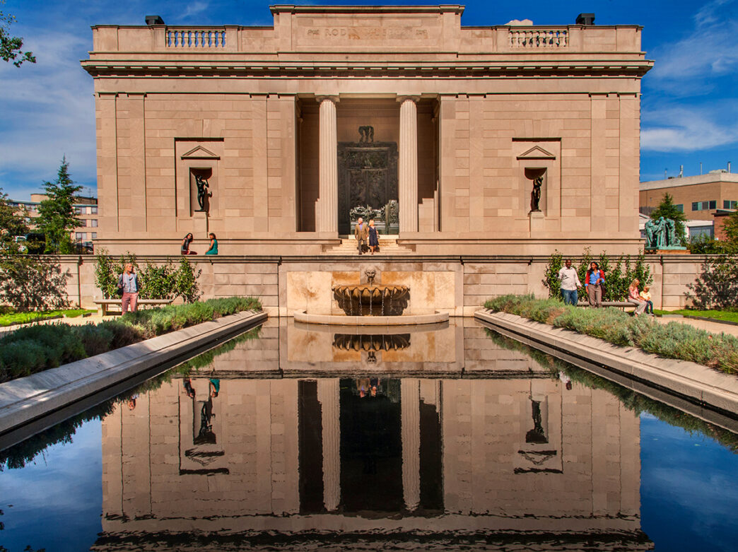 People walk around the gardens surrounding the reflecting pool at the Rodin Museum in Philadelphia.