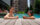 Two people relax in the pool at The W in Philadelphia. They both wear sunglasses and hold a drink in their hands.