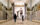 Two people look up at a large bronze statue of Benjamin Franklin displayed in the Masonic Temple in Philadelphia.