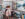 Two women and two children admire abstract paintings displayed in a vendor tent at the Manayunk Arts Festival.