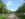 Two people walk down a brick walkway lined with flagpoles towards a building at Washington Crossing Historic Park.