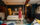 A woman in a red dress rolls her suitcase through a guest room at Guild House Hotel in Philadelphia.