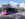 A pink and purple PHLASH bus passes Eastern State Penitentiary in Philadelphia.