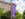 A purple sign hangs from a telephone pole with the PHLASH logo and Independence Visitor Center written on the flag.