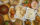 Rice, naan and a variety of Indian dishes are displayed on a table with a yellow table cloth.